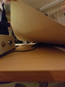 Boundary mic on desk being hidden beneath folder. 